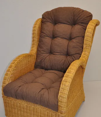 A close-up shot of a brown cushion on a wicker chair.