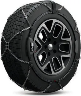 A close-up, studio shot of a snow chain fitted onto a car tire and wheel.