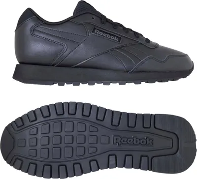 A black Reebok shoe and its sole are shown against a white background.