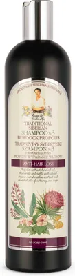 A bottle of shampoo against hair loss, with botanical illustrations on the label.