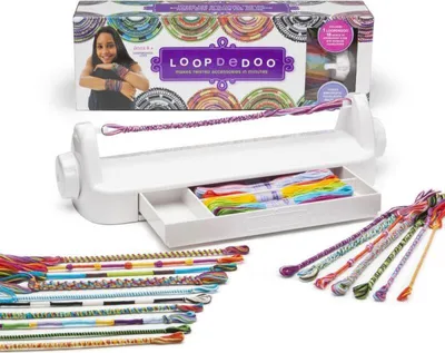 A LoopDeDoo bracelet making kit is displayed on a white surface, with the packaging in the background and finished bracelets in the foreground.