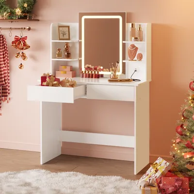 A white vanity table with a lighted mirror, makeup, and gifts, set up in a room decorated for Christmas.