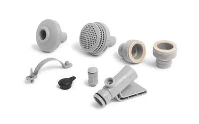 A collection of various plastic plumbing and filter components for a garden pool.