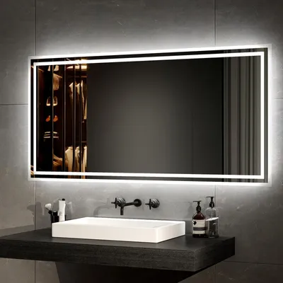 A modern bathroom vanity with a rectangular sink and a large, illuminated mirror above it.