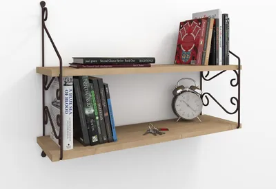 A two-tiered wooden shelf mounted on a white wall, displaying books, an alarm clock, and keys.