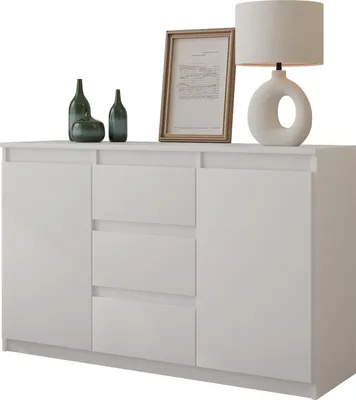A white sideboard with decorative items on top, including bottles, a framed picture, and a lamp.