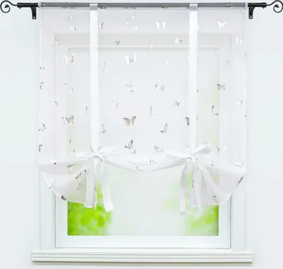A white sheer curtain with a butterfly pattern hangs in a window.
