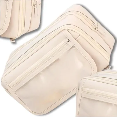 A beige toiletry bag with multiple compartments and a clear front pocket, shown from a slightly elevated angle.