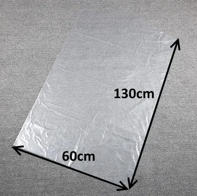 A transparent plastic sheet laid out on a grey surface, with dimensions indicated.