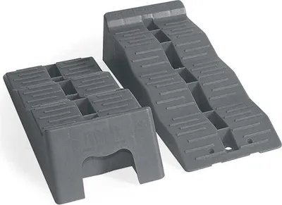 Two gray plastic leveling wedges for vehicles, shown on a white background.
