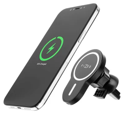 A black smartphone is shown charging wirelessly next to a black car phone holder.