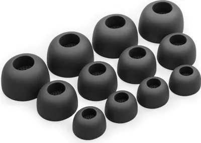 A collection of black silicone ear tips for headphones, arranged in a scattered pattern on a white background.