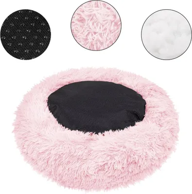 A round, fluffy pink pet bed with a black center cushion. Three circular insets show close-ups of the materials: a black textured fabric with small dots, fluffy pink material, and white stuffing.