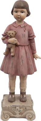 A figurine of a young girl holding a teddy bear, standing on a decorative base.