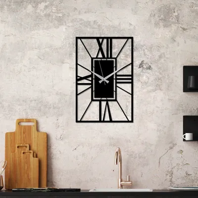 A modern kitchen setting with a wall clock, cutting boards, and a faucet.