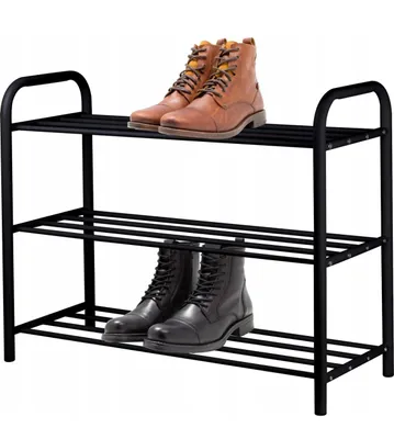 A black metal shoe rack with two pairs of boots on it.