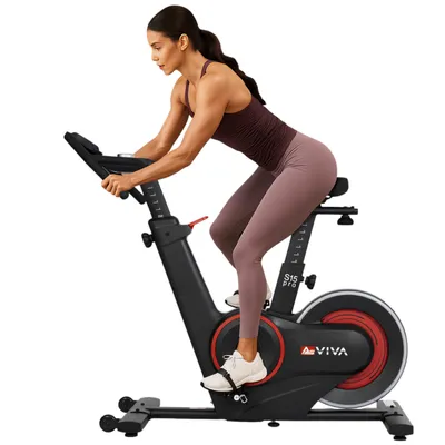 A woman is riding an indoor exercise bike.