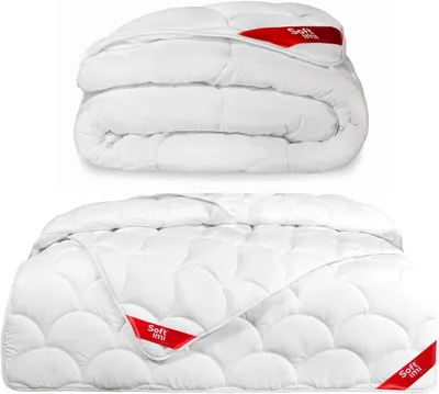 A folded and an unfolded white comforter are displayed against a white background.