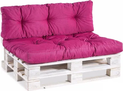 A pink pallet sofa cushion set on a white wooden pallet.