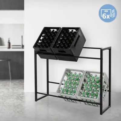 A metal rack holding two black crates of dark bottles on the top shelf and two gray crates of green bottles on the bottom shelf, set against a white wall with a hint of a kitchen in the background.
