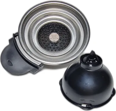 A close-up view of coffee machine parts, specifically a filter holder and a lid, against a white background.