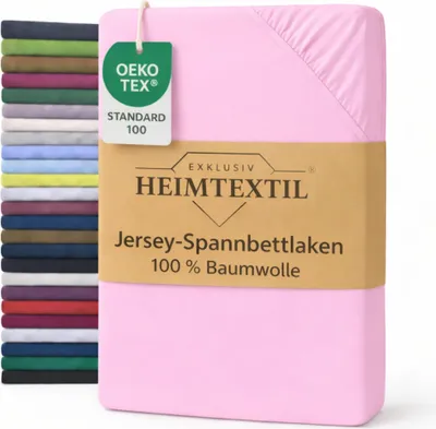 A stack of folded bed sheets in various colors is shown on the left, with a pink fitted sheet prominently displayed on the right, featuring product information labels.