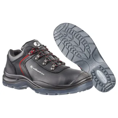 A pair of black safety shoes with red accents and a separate sole are shown against a white background.