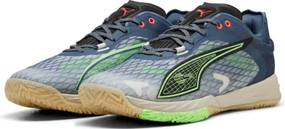A pair of blue Puma handball shoes with green accents and tan soles are shown against a white background.