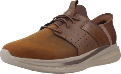 A single brown SKECHERS SLIP-INS SLADE - ZACHARY shoe is shown from a side angle against a white background.