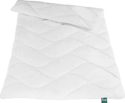 A white duvet is laid out flat on a white background.