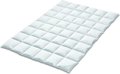 A white quilted comforter is shown from a diagonal angle against a white background.