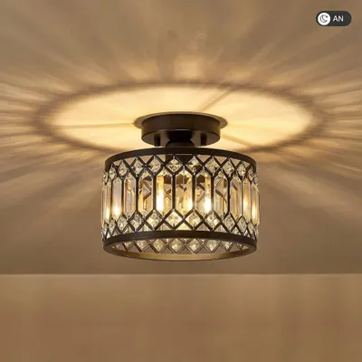 A close-up shot of a black crystal LED ceiling light mounted on a ceiling, casting intricate shadows.