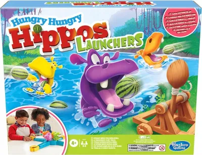 The image shows the box of the Hungry Hippos Launchers board game, featuring cartoon hippos and watermelons.