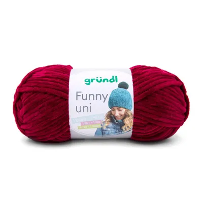 A ball of red yarn with a label showing a person wearing a blue hat.