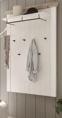 A white wooden coat rack with several hooks, a shelf, and a hat and container on top, with a scarf and jacket hanging on it.