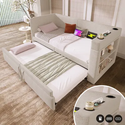 A beige daybed with a pull-out trundle bed is set up in a room with soft lighting and a decorative plant.