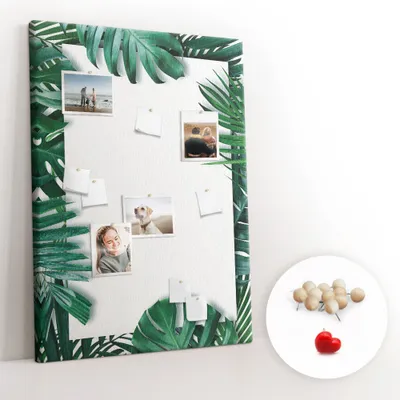 Imagen del producto de Tablero de corcho con chinchetas - Panel con chinchetas para fotografías y notas - 100x140 cm - 100 chinchetas de madera - Marco con diseño de Monstera