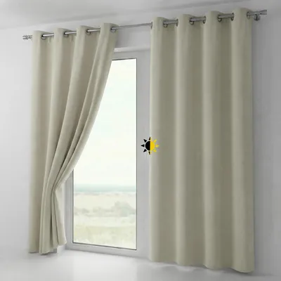 A window with curtains drawn to the side, showing a landscape view outside.