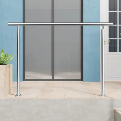 A stainless steel handrail is installed on an outdoor patio in front of a blue wall and glass doors.