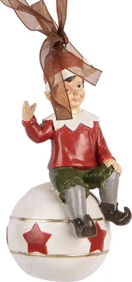 A Christmas ornament of an elf sitting on a star-decorated ball.