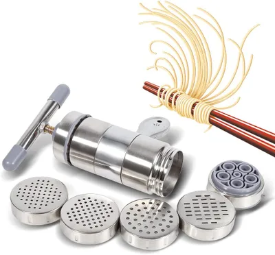A manual pasta maker with various attachments and freshly made pasta.