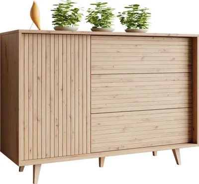 A light wood dresser with a fluted door and three drawers, topped with three potted plants and a decorative bird.