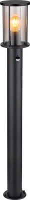A black outdoor lamp with a glass shade and a lit bulb.