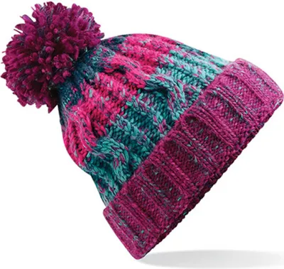 A close-up studio shot of a knitted beanie with a pom-pom.