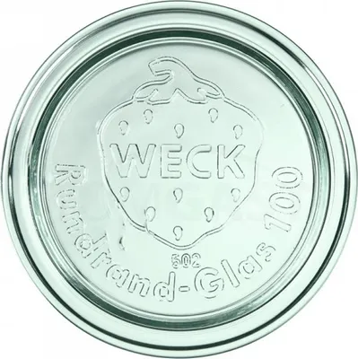 A close-up view of a glass jar lid with embossed text and a strawberry design.