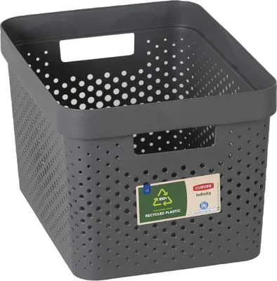 A dark gray storage basket with a perforated design and white polka dots on the inside.