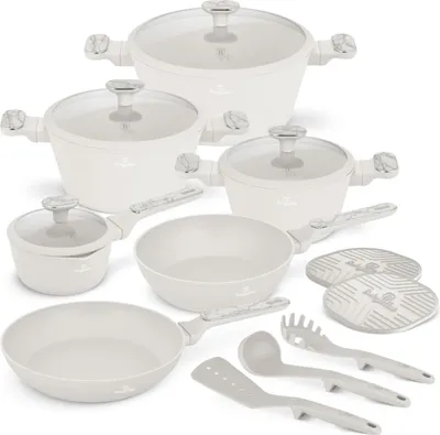 A collection of white cookware and utensils arranged on a white background.