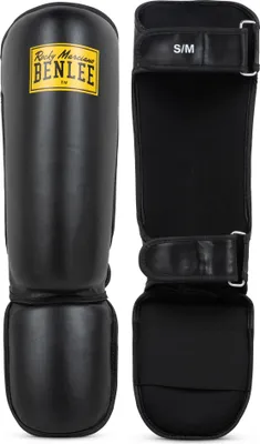 A pair of black shin guards for martial arts or combat sports.