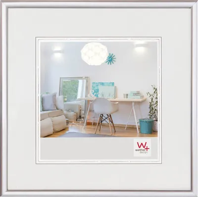 A bright, modern home office or living space with a desk, chair, and sofa.