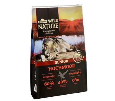 A bag of dog food with a wolf image and sunset.